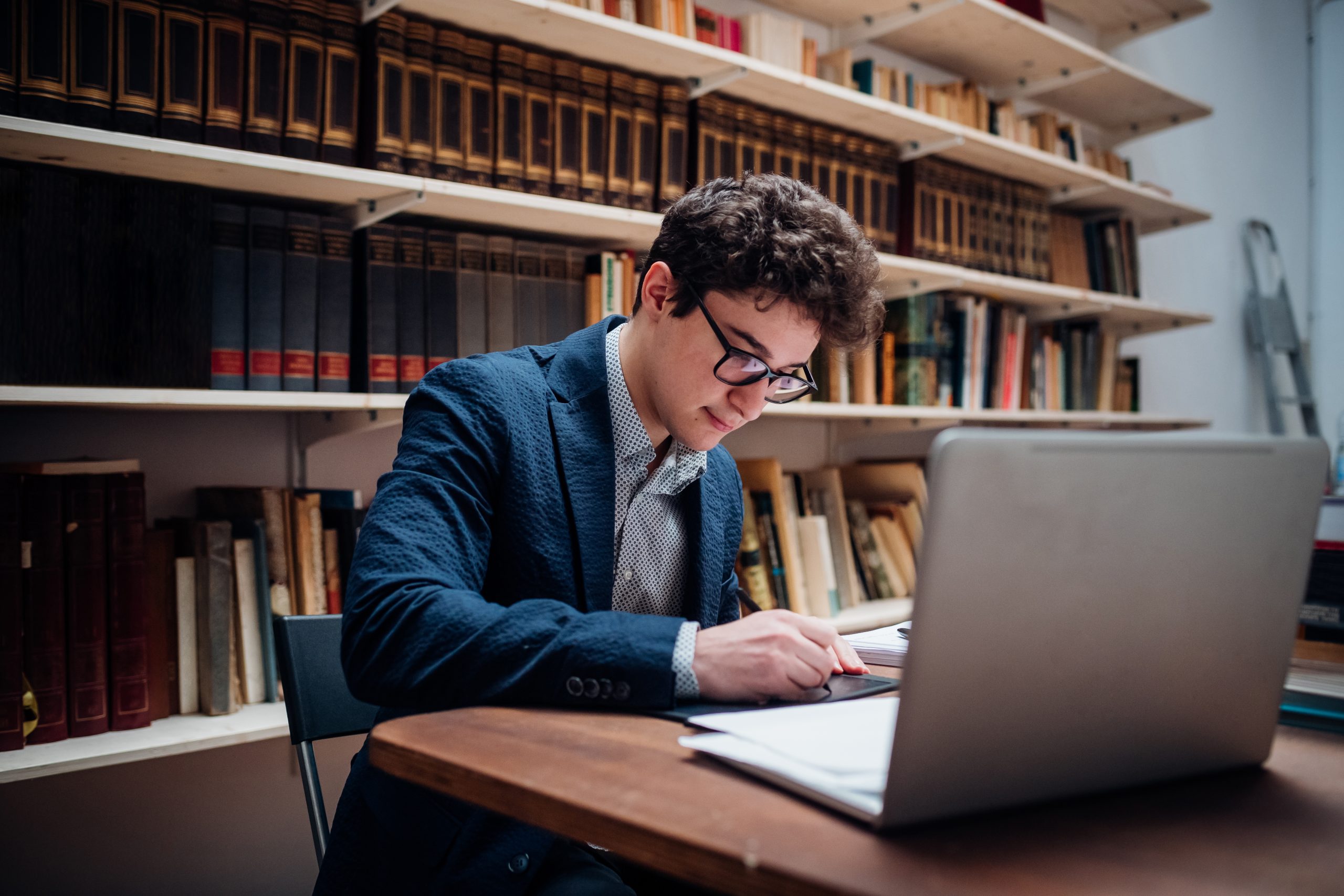 Young adult student preparing exam following online lesson - Man